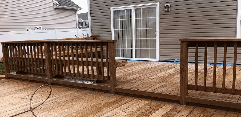 Deck sealing service protecting a backyard wood deck and railings in Ann Arbor, MI