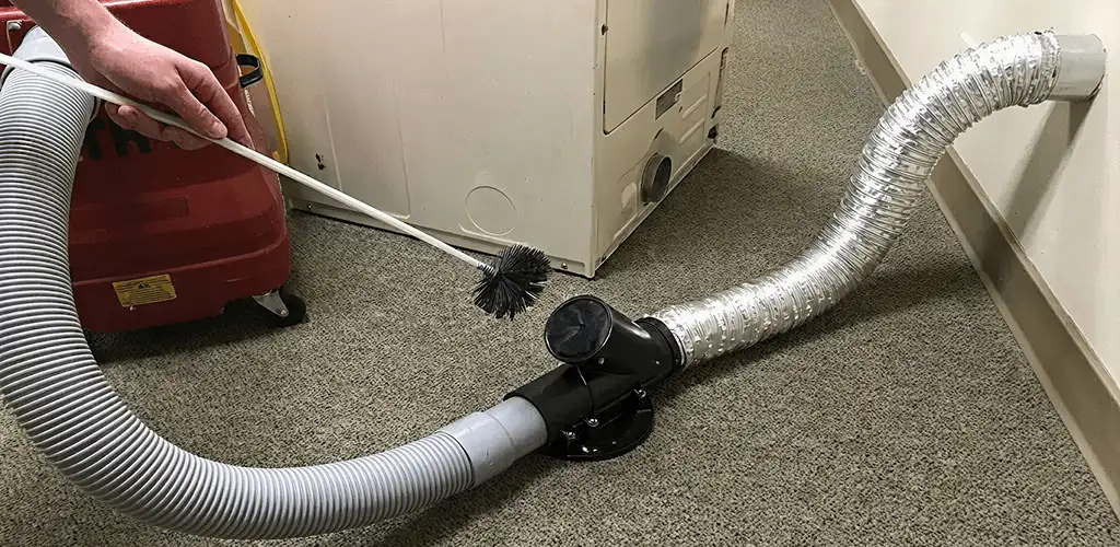 Dryer vent cleaning service removing lint from a dryer duct connection in Ann Arbor, MI