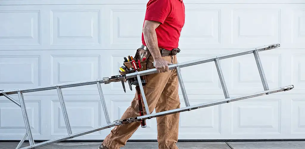 Garage door repair technician arriving with tools and ladder in Ann Arbor, MI