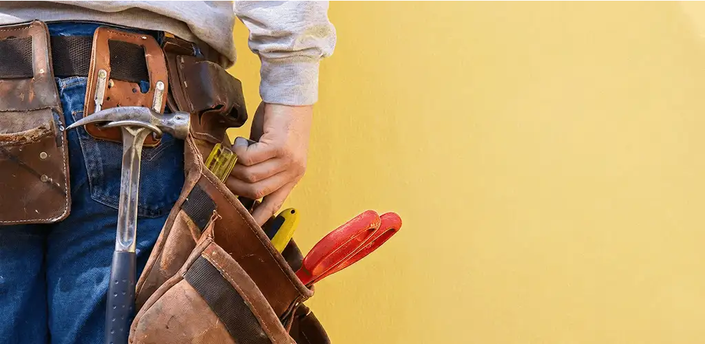 Handyman with tool belt ready for home repairs and maintenance in Ann Arbor, MI
