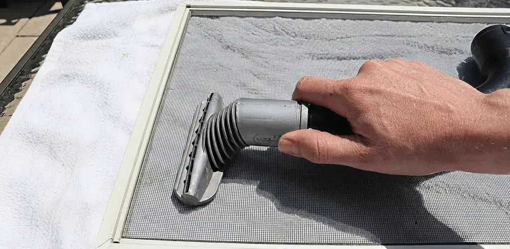 Window screen repair cleaning and fixing a damaged screen mesh in Ann Arbor, MI
